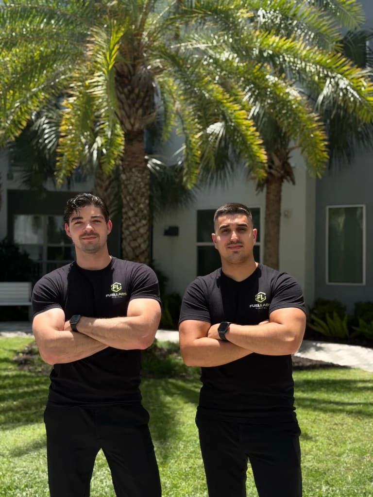 FuelLabs founders viewed from behind in branded shirts outdoors
