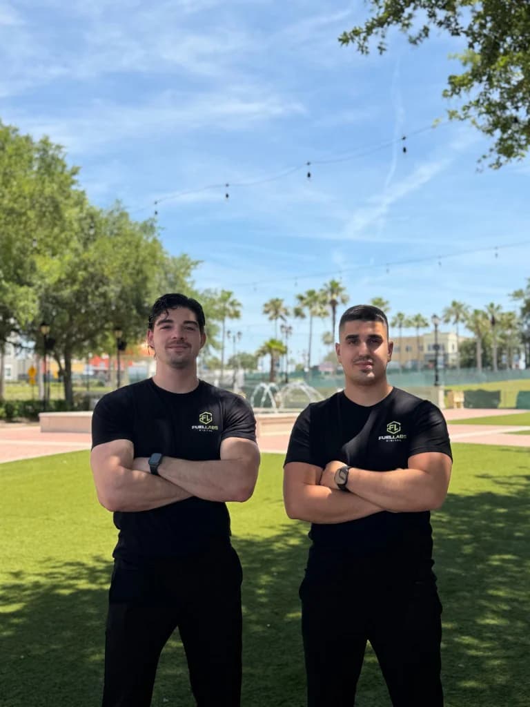 FuelLabs founders standing outdoors near architecture columns