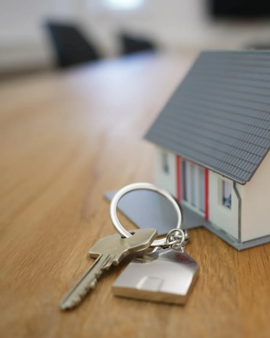 Real estate ad with keys and home visual, headline, supporting text, and CTA.