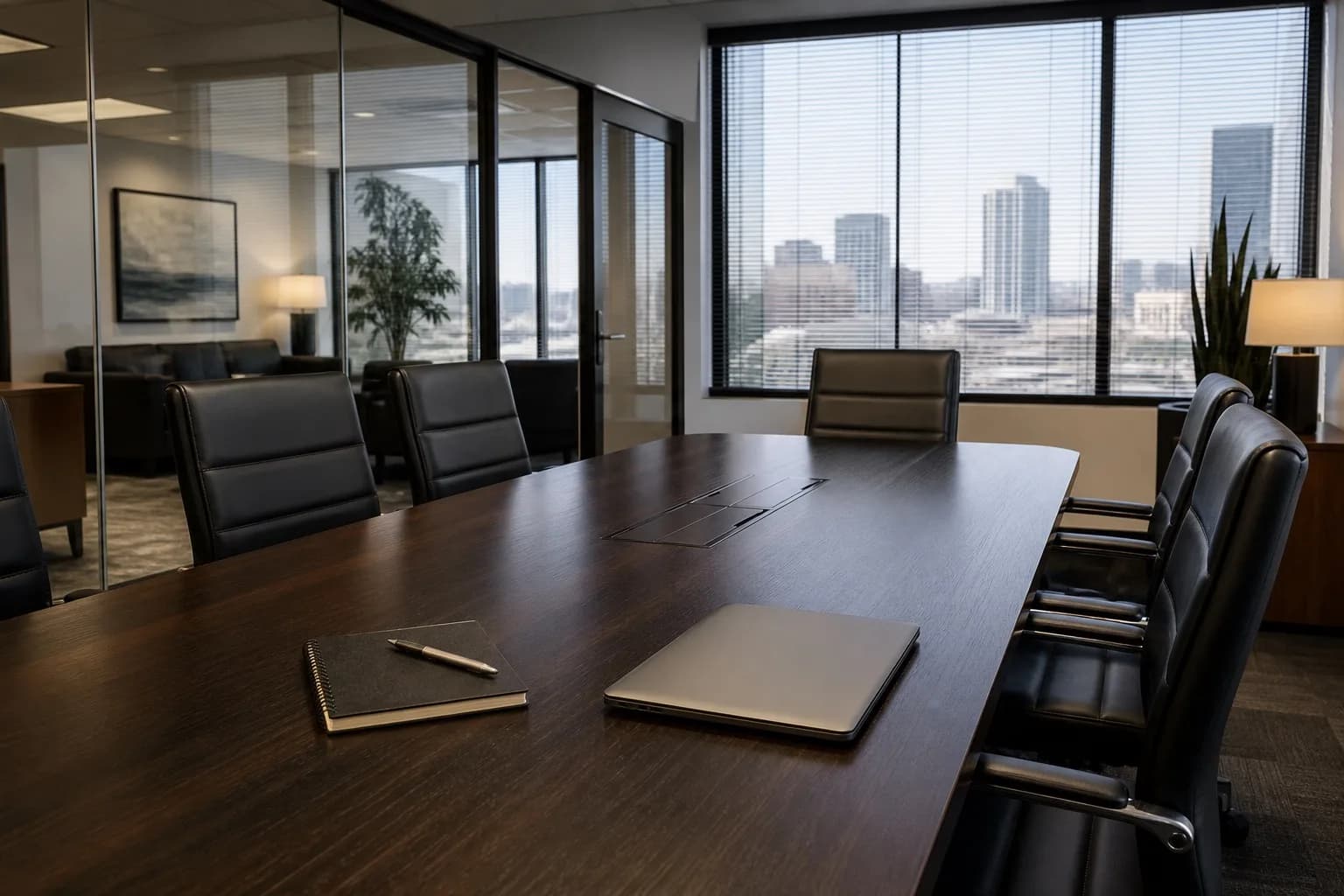 Empty modern law firm conference room with dark wood table and city view