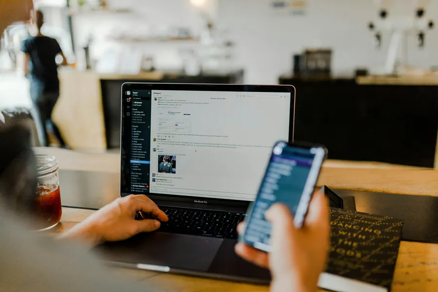 Smartphone in hand showing active screen—notifications, routing, and instant customer follow-up.