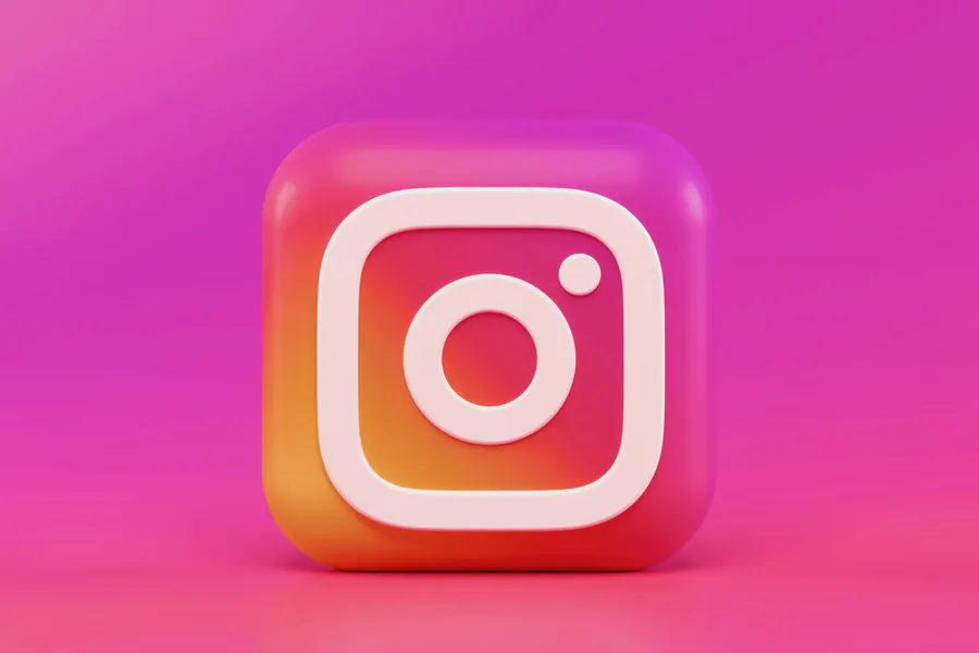 Phone showing social interfaces—paid social creative, feeds, and performance marketing context.