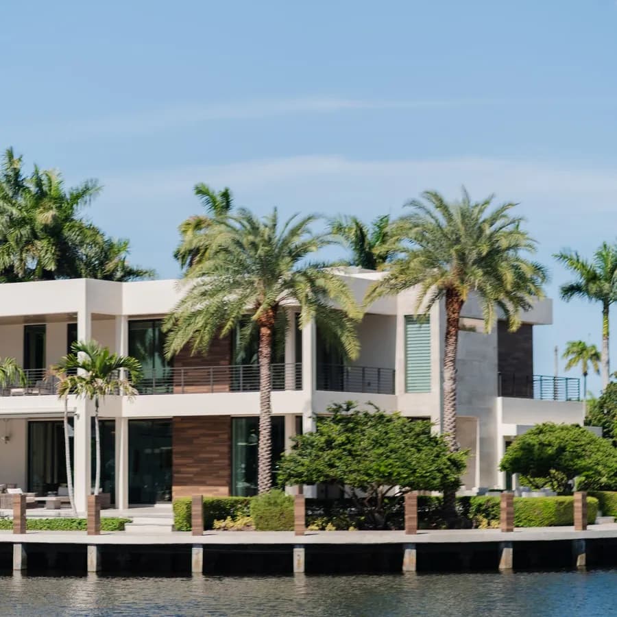 Waterfront Florida villa with palm trees along a canal