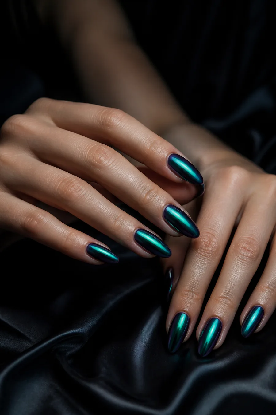 Close-up of iridescent teal manicure.